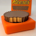 3D printed round chocolate-style clicker fidget toy shown from the front