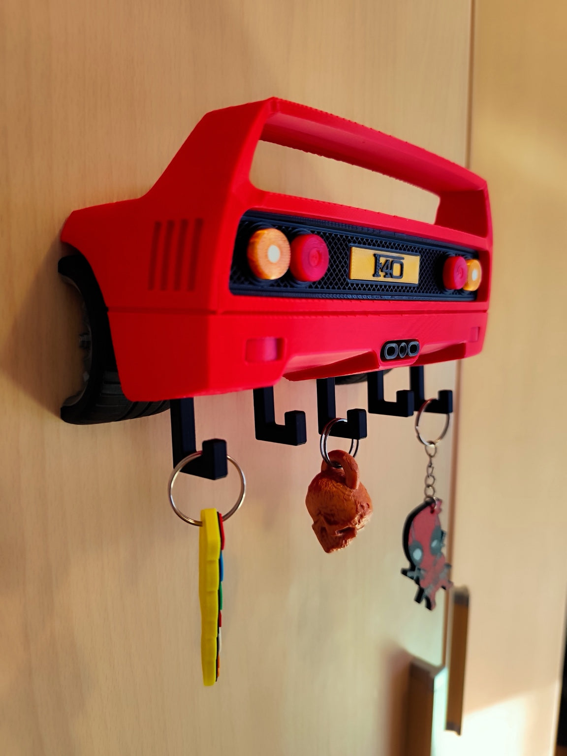 Red F40-inspired 3D printed wall key holder mounted with keys hanging from hooks