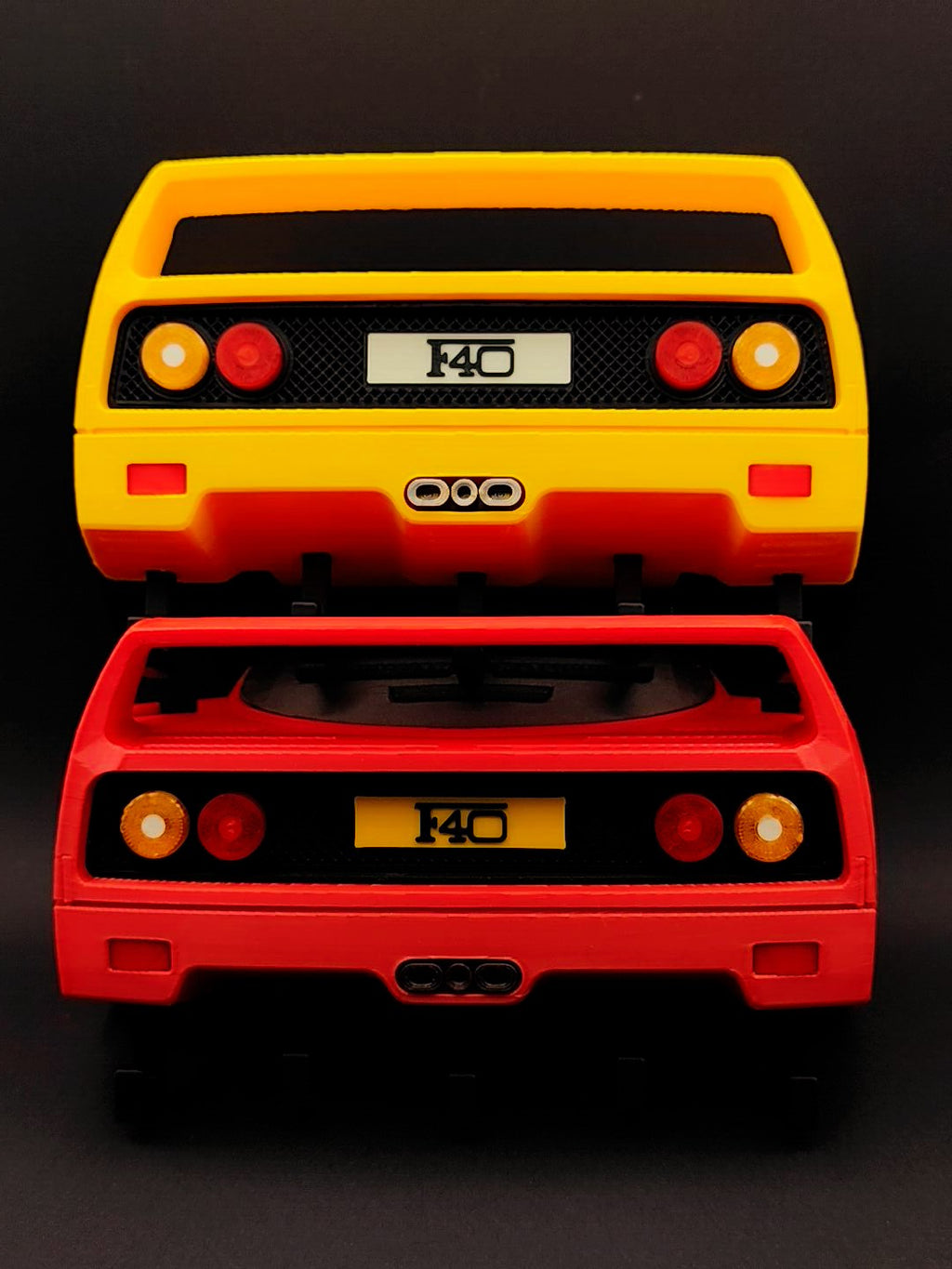 Red and yellow F40-inspired 3D printed wall key holders shown together