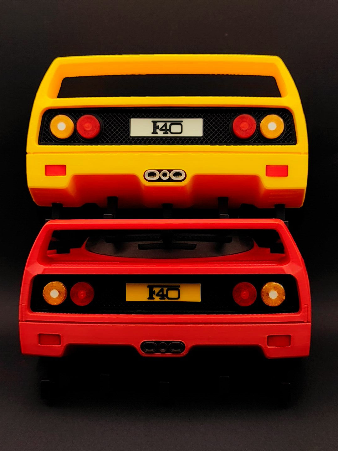 Red and yellow F40-inspired 3D printed wall key holders shown together