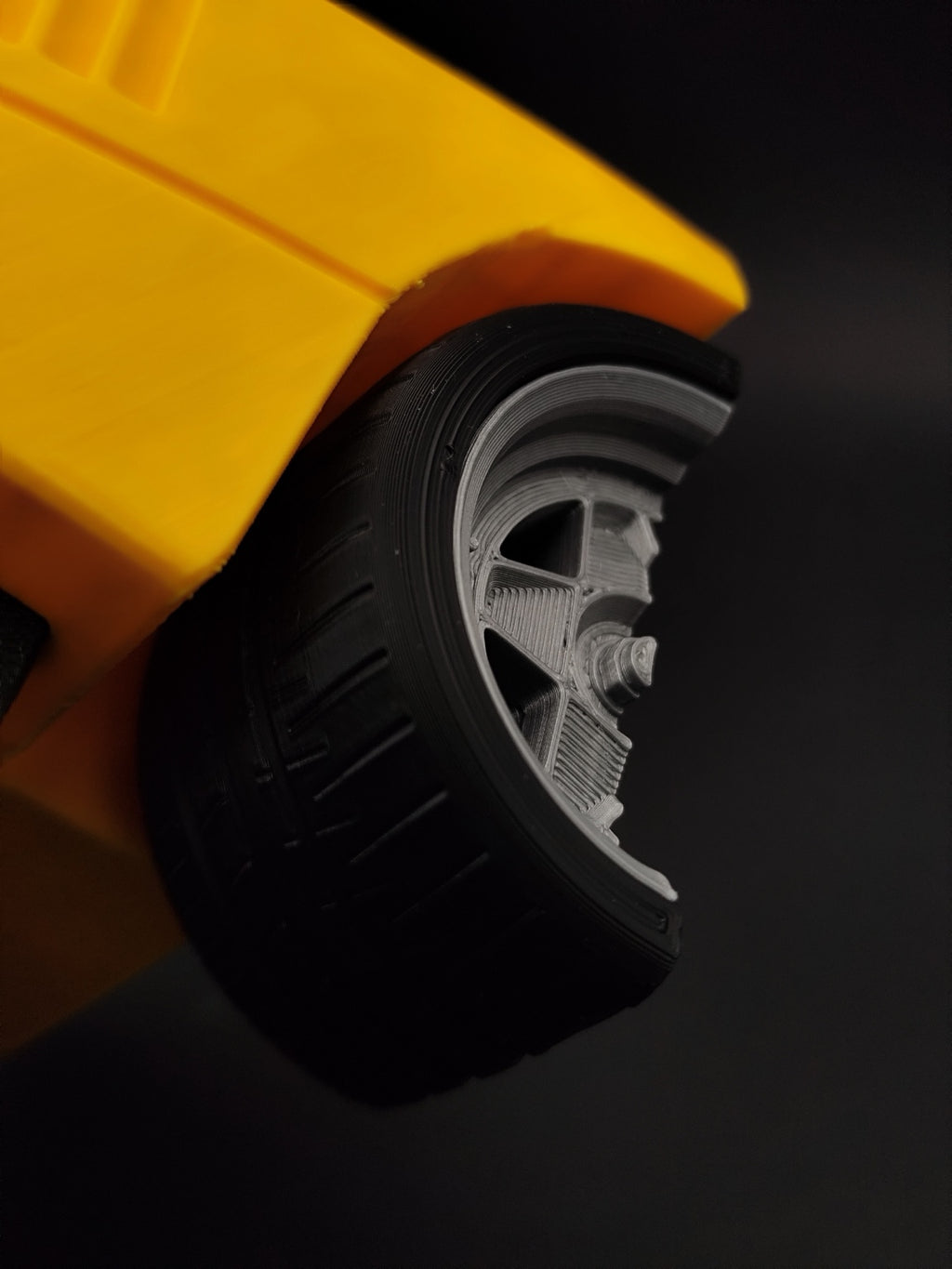 Close-up of wheel detail on yellow F40-inspired 3D printed automotive key holder