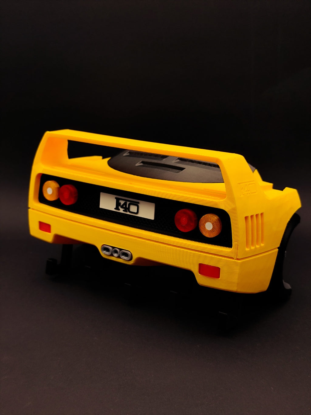 Yellow F40-inspired 3D printed key holder rear view on black background