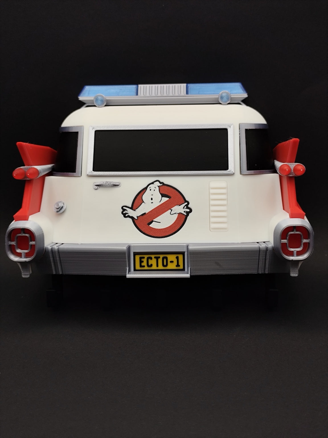 Front view of 3D printed Ghostbusters Ecto-1 wall key holder with five black hooks