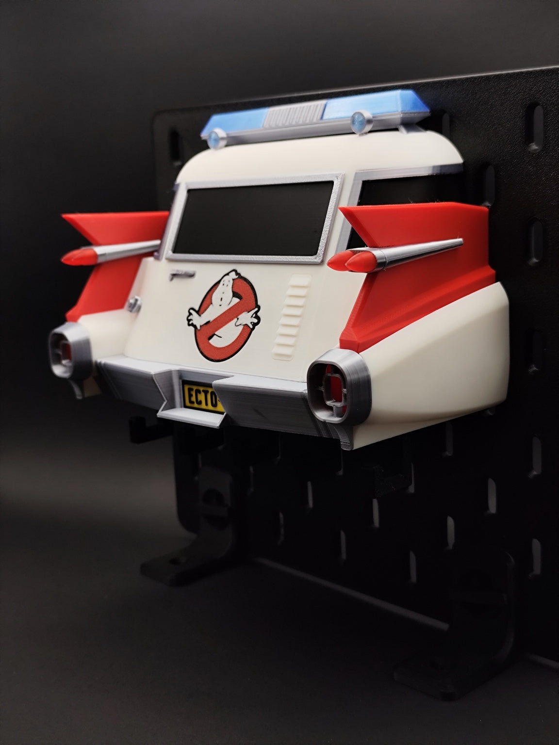 Ghostbusters Ecto-1 3D printed key holder displayed on a pegboard