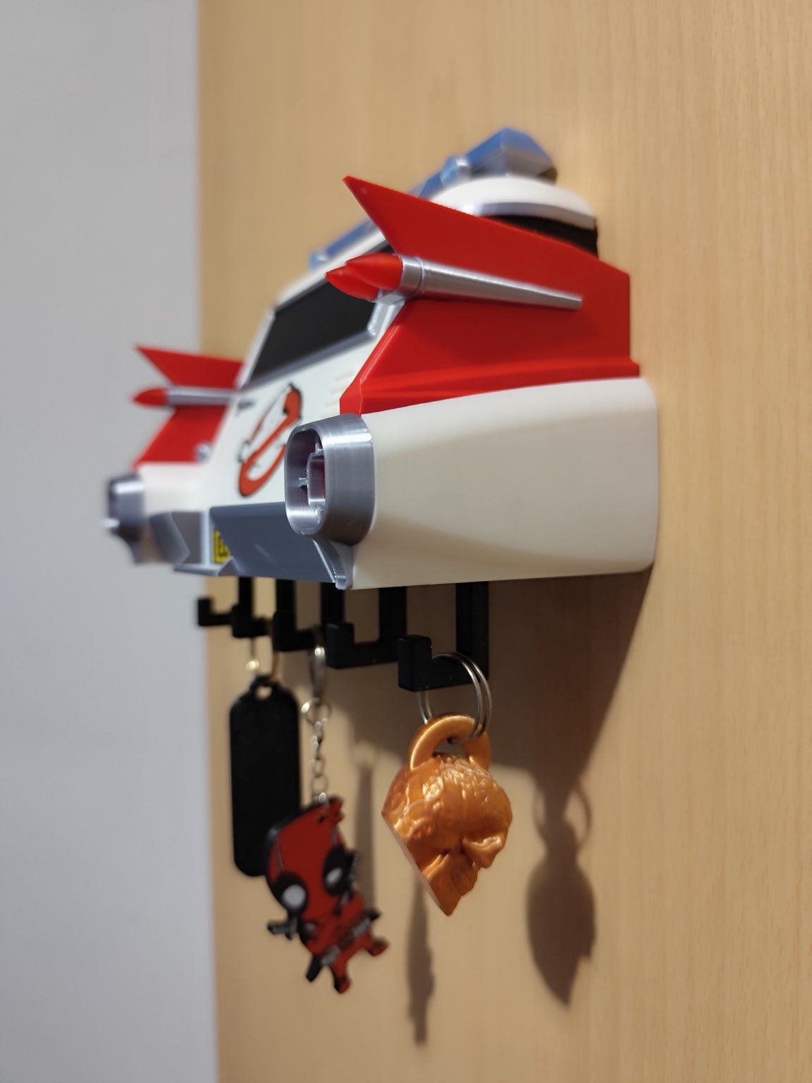Side profile of Ghostbusters Ecto-1 3D printed key holder mounted on a wall