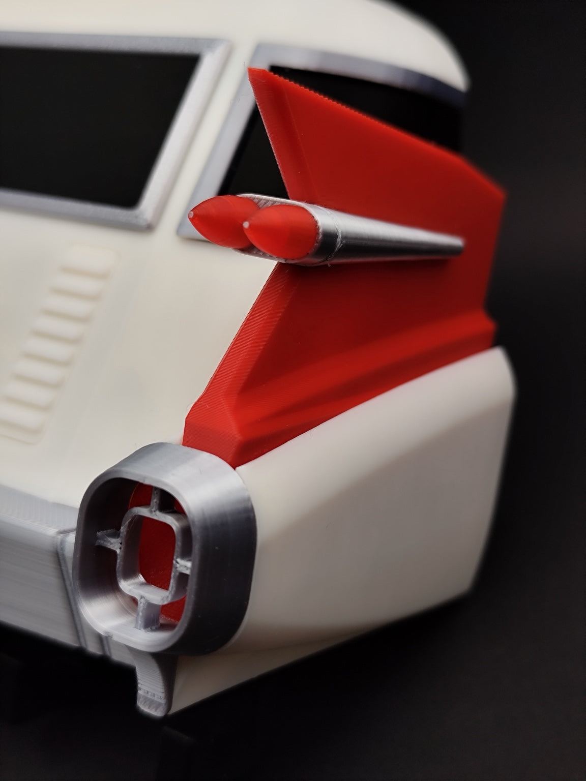 Close-up of red fin and silver tail light details on 3D printed Ecto-1 key holder