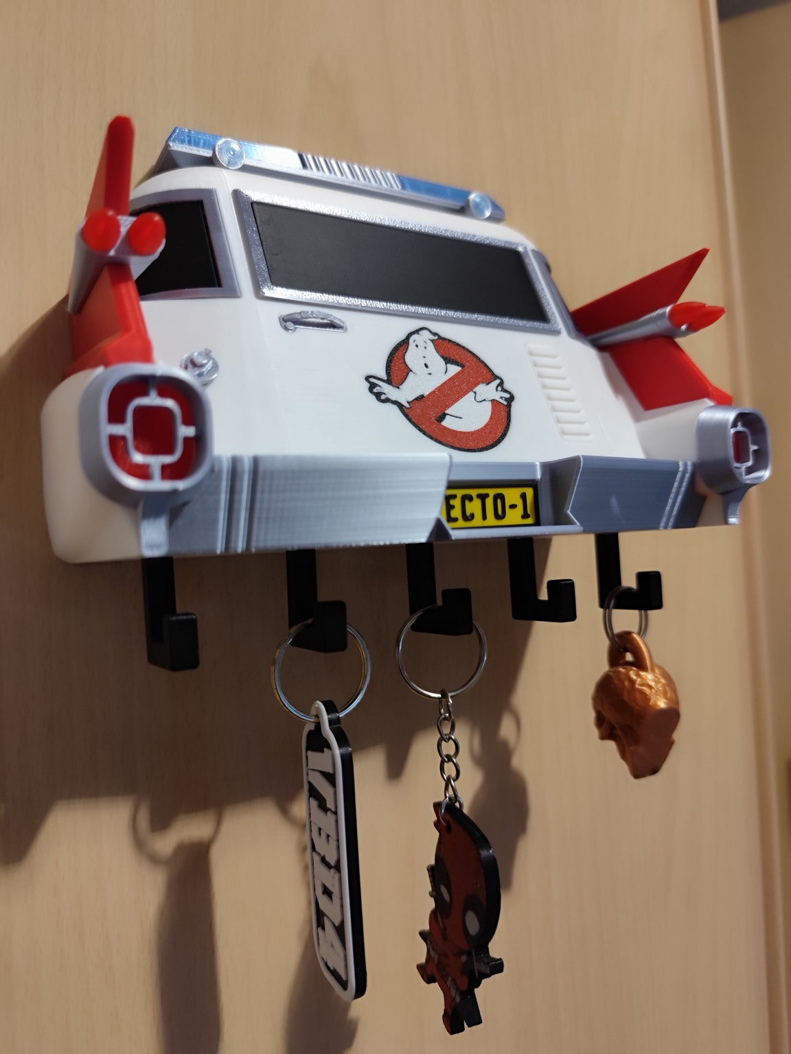 3D printed Ghostbusters Ecto-1 key holder mounted on wall with keys hanging from five hooks