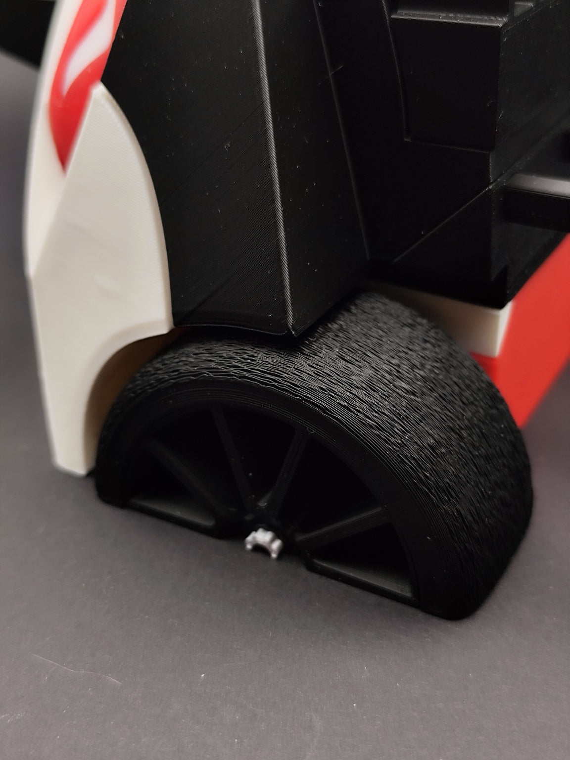 Close-up of the M4 GT3 black wheel and rear diffuser