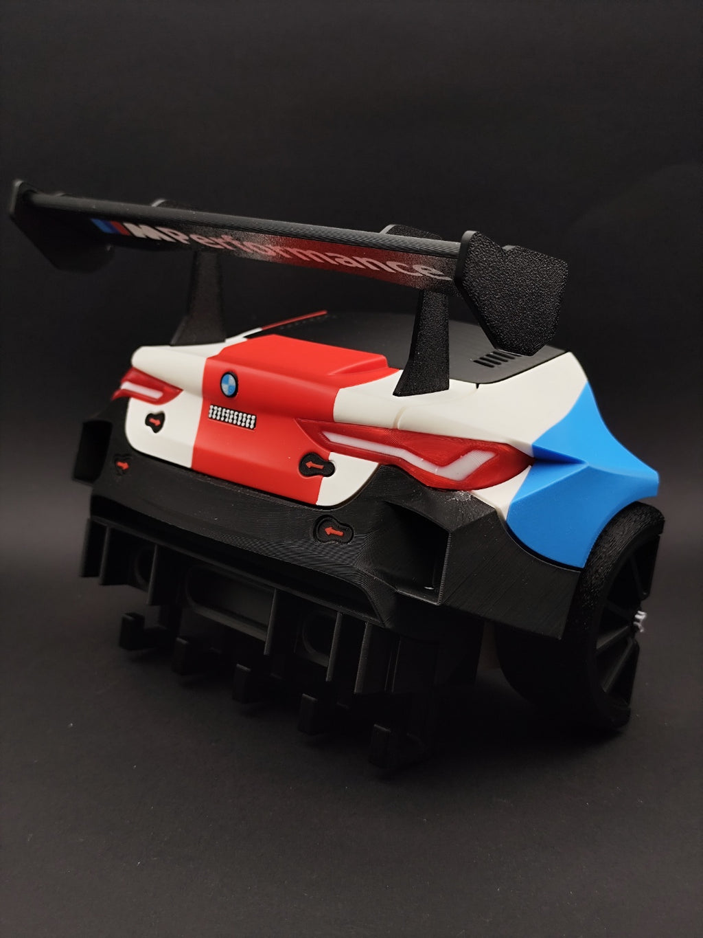 Angled rear view of the M4 GT3 key hanger on a dark background