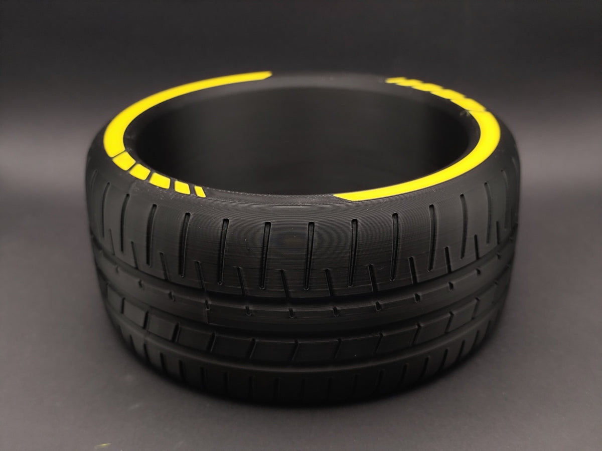 Empty tire catchall bowl showing tread detail and yellow rim accents