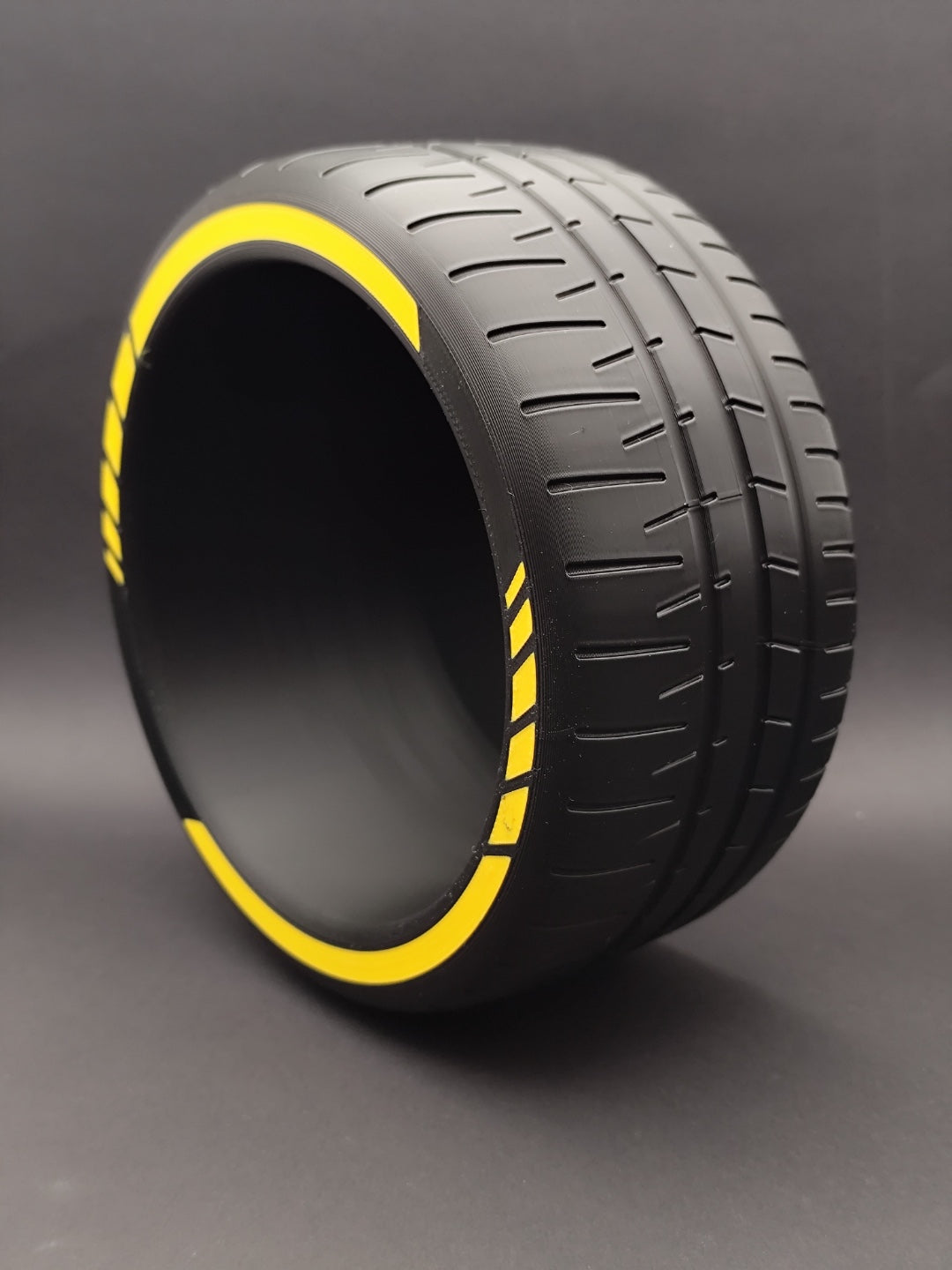 Angled view of empty tire catchall bowl with yellow rim accents